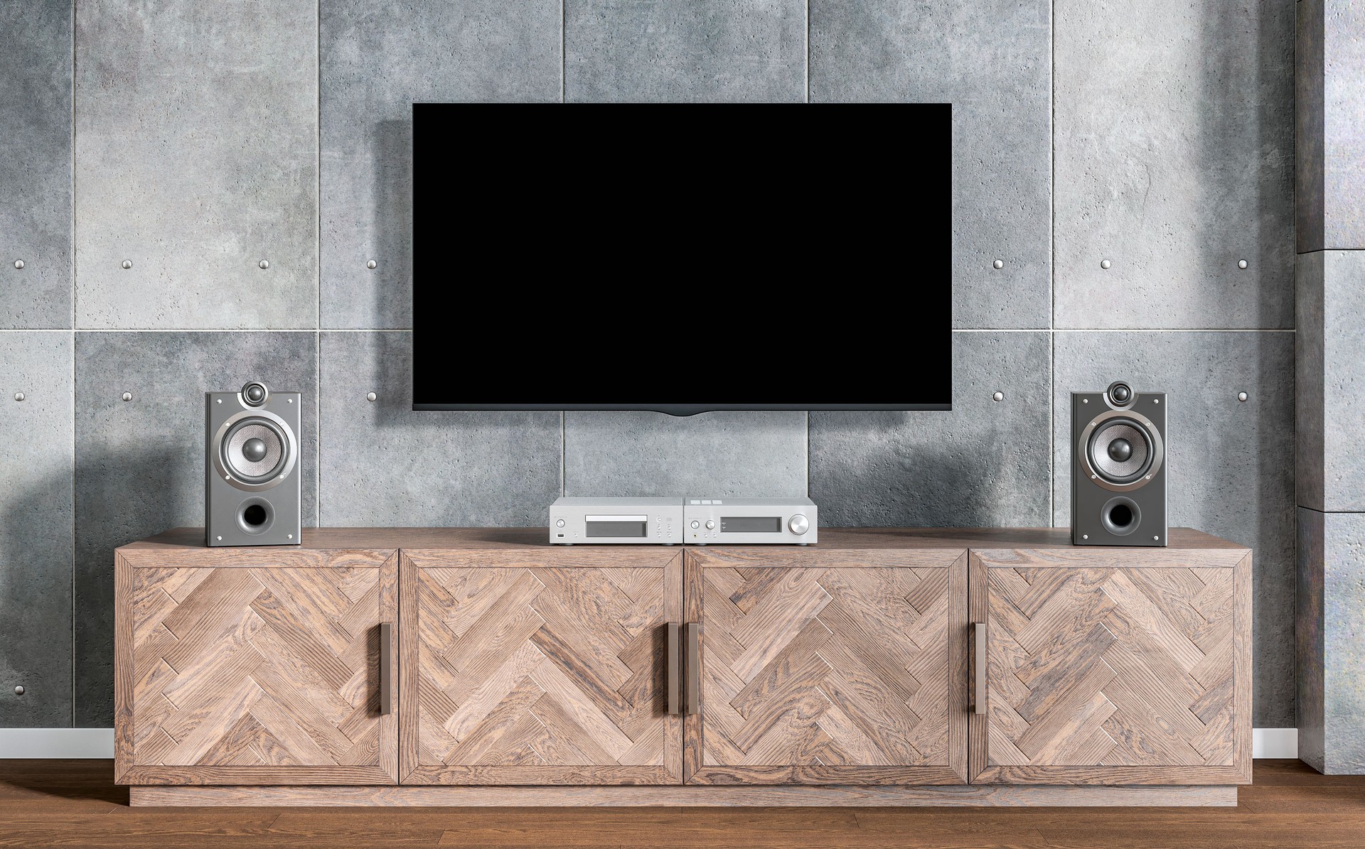 Modern industrial living room with a stereo system and speakers on an empty hardwood cabinet under a wall mounted LCD TV, on gray cement background